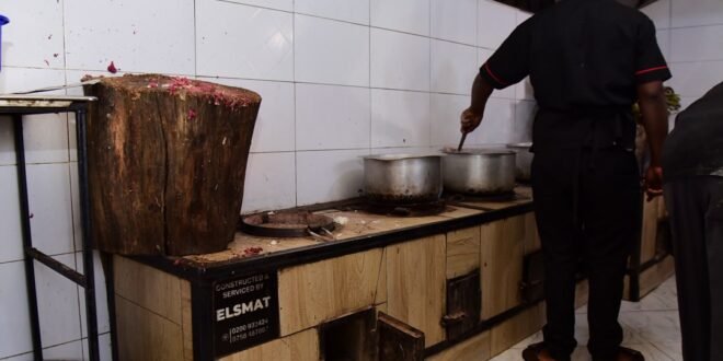 Muhuza John Bosco, Head Chef at Polland Food Centre, preparing food from the restaurants smart kitchen