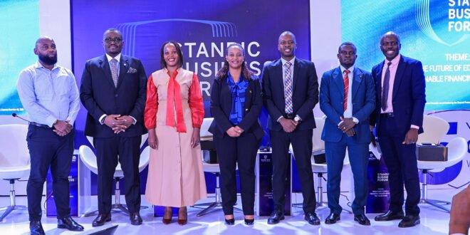 Tunde Thorpe (2 L) , Executive Head of Business and Commercial Banking pose for a group photo with panelists during the Regional Forum in Kampala.JPG