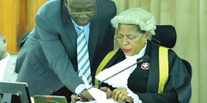 Patrick Isiagi, the chairperson of the parliamentary budget committee, confers with then Speaker Anita Among during 2024 budget deliberations. (Photo courtesy of the Parliament of Uganda)