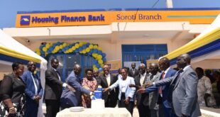 Vice President Jessica Alupo, and Michael Mugabi MD Housing Finance Bank(Center) joins other HFB officials to cut the cake during the opening of Soroti Branch