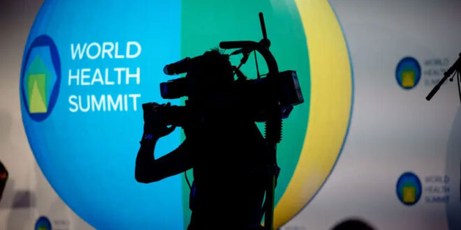 Photographer recording the World Health Summit.