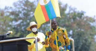 M7 hands over a flag to youthful Energetic Wakooli Matembu