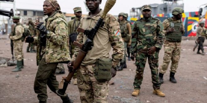 Members of the M23 rebel group gather to supervise Congolese potential recruits for the M23 rebel group before being taken to training centres run by M23 rebels.