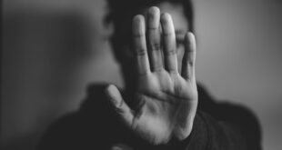 A woman raises her hand, calling for an end to GBV.