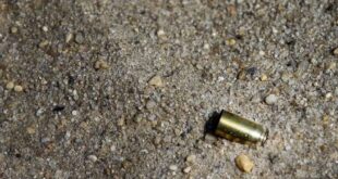 Cartridge casing lays on the ground.