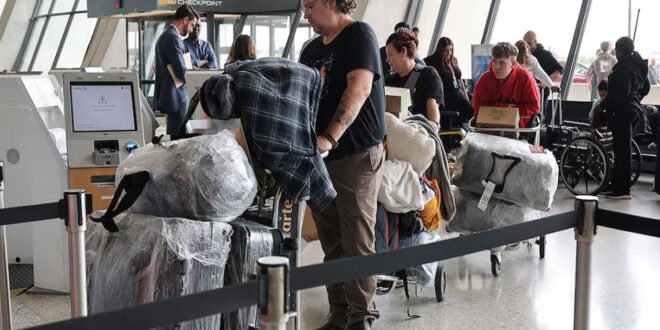 People from the first group of white South Africans granted refugee status for being deemed victims of racial discrimination under United States (US) President Trump's Refugee plan, check in for a connecting flight, at Dulles International Airport, in Dulles, Virginia, US on May 12, 2025.