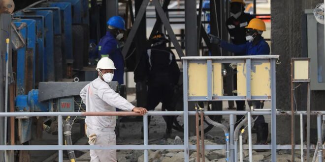 Workers are pictured at the Prospect Lithium Zimbabwe mine in Goromonzi, Zimbabwe on 09 January 2024.