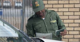 A Border Management official checks documents at the border.
