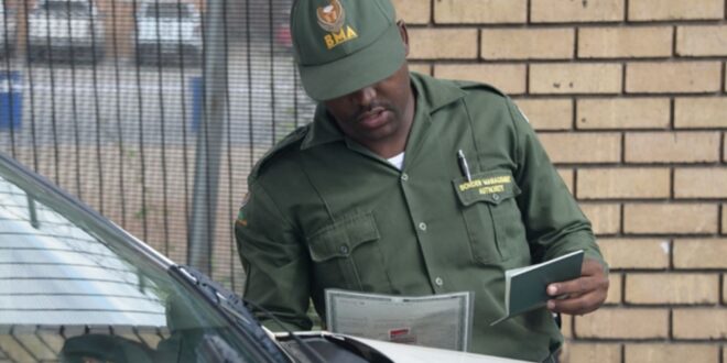 A Border Management official checks documents at the border.