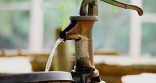 A drum being filled with water.