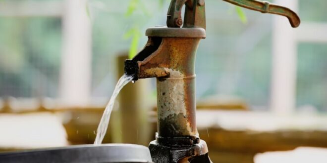 A drum being filled with water.