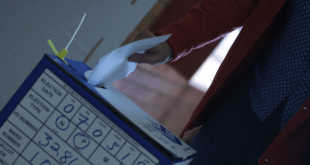 File Image: A voter submits their ballot paper into the ballot box.