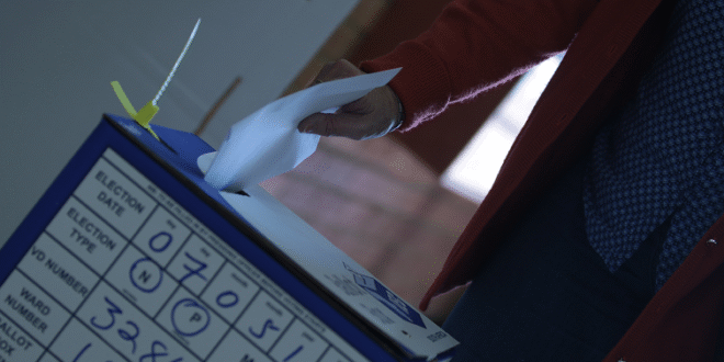 File Image: A voter submits their ballot paper into the ballot box.