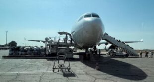 Chadian workers load luggage and travelers' belongings before the departure of an EgyptAir airlines plane to Egypt at N'Djamena International Airport in the capital city of N'Djamena, Chad on December 2, 2025.