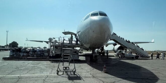 Chadian workers load luggage and travelers' belongings before the departure of an EgyptAir airlines plane to Egypt at N'Djamena International Airport in the capital city of N'Djamena, Chad on December 2, 2025.