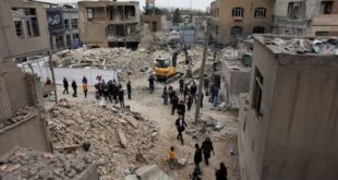 People walk at the site of a strike, amid the US-Israeli conflict with Iran, in Tehran, Iran on March 15, 2026.