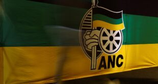 An ANC delegate walks past a banner during the 5th National General Council meeting.