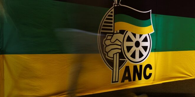 An ANC delegate walks past a banner during the 5th National General Council meeting.