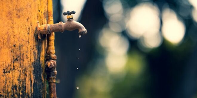 Water leaking from a tap.