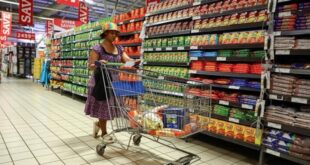A woman uses a trolley as she shops at a Pick n Pay store at Maponya mall in Soweto, South Africa
